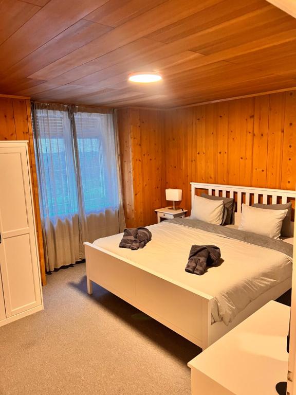 a bedroom with two beds in a room with wooden walls at AFA1 in Göschenen