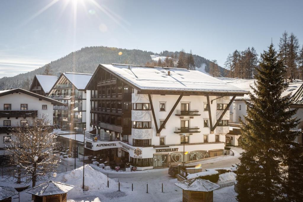 ein großes Gebäude mit Schnee auf dem Dach in der Unterkunft Alpenlove - Adult SPA Hotel in Seefeld in Tirol