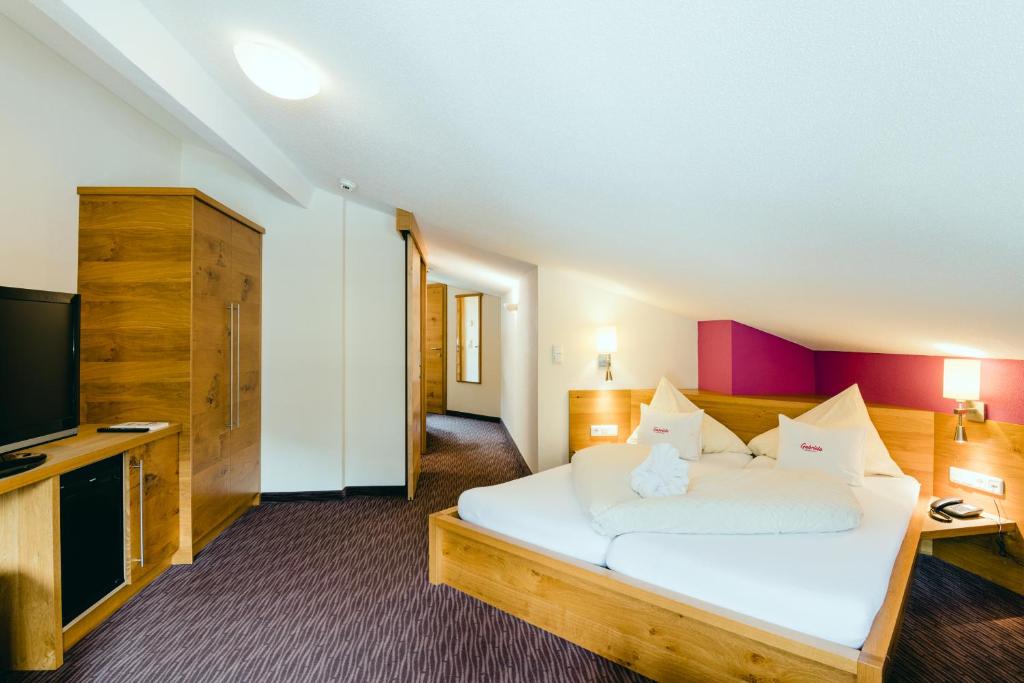 Posteľ alebo postele v izbe v ubytovaní Hotel Gabriela