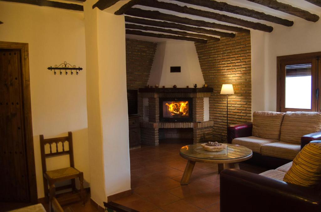 a living room with a couch and a fireplace at Balcón de Válor in Válor