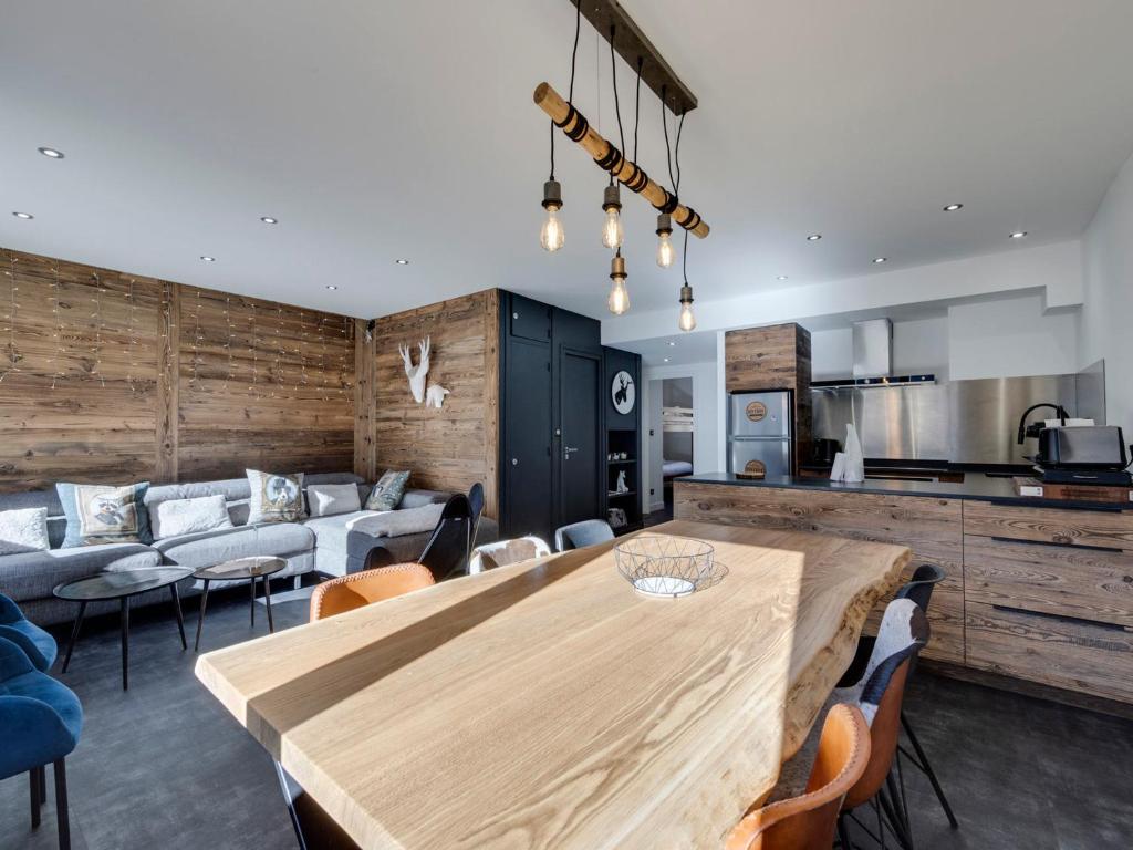 a kitchen and living room with a wooden table and chairs at Appartement Tignes, 3 pièces, 6 personnes - FR-1-641-4 in Tignes
