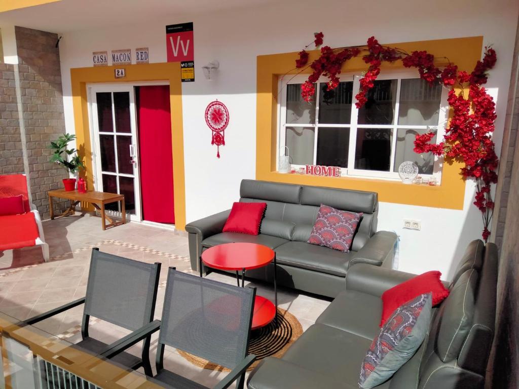 a living room with a couch and a table at Casa MACON RED in Caleta De Fuste