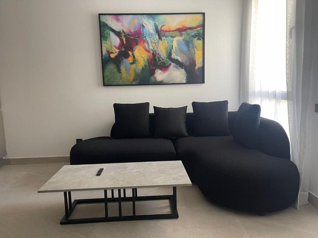a living room with a couch and a coffee table at Magic Appartement Luxury Gauthier 10 in Casablanca