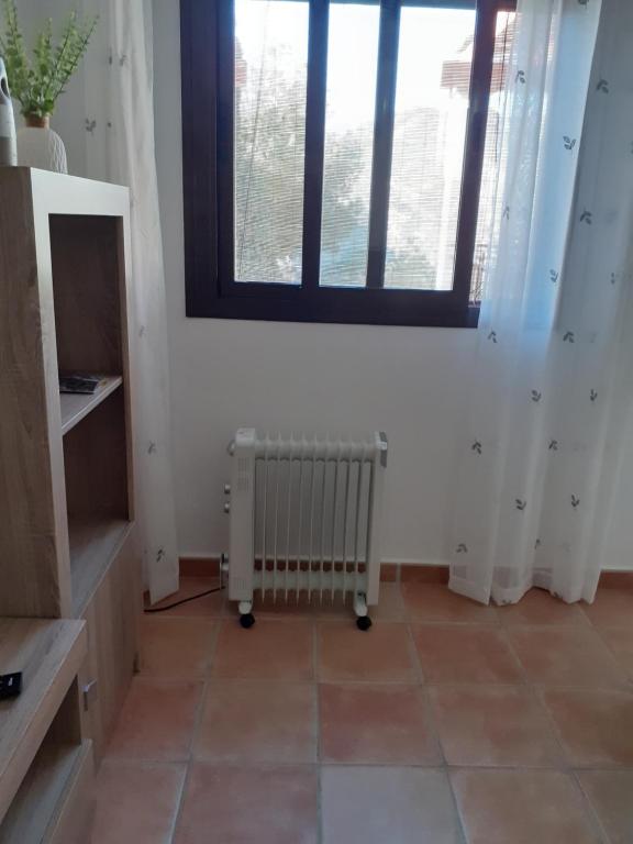 a room with a radiator and a window at Casa Luna in Lentegí