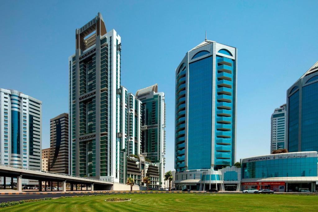 a group of tall buildings in a city at Four Points by Sheraton Sharjah in Sharjah