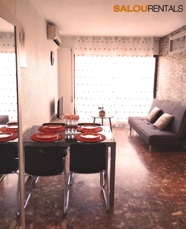 a living room with a table and chairs and a couch at Blue Sky Montblanc - Swimming Pool & AC in Salou