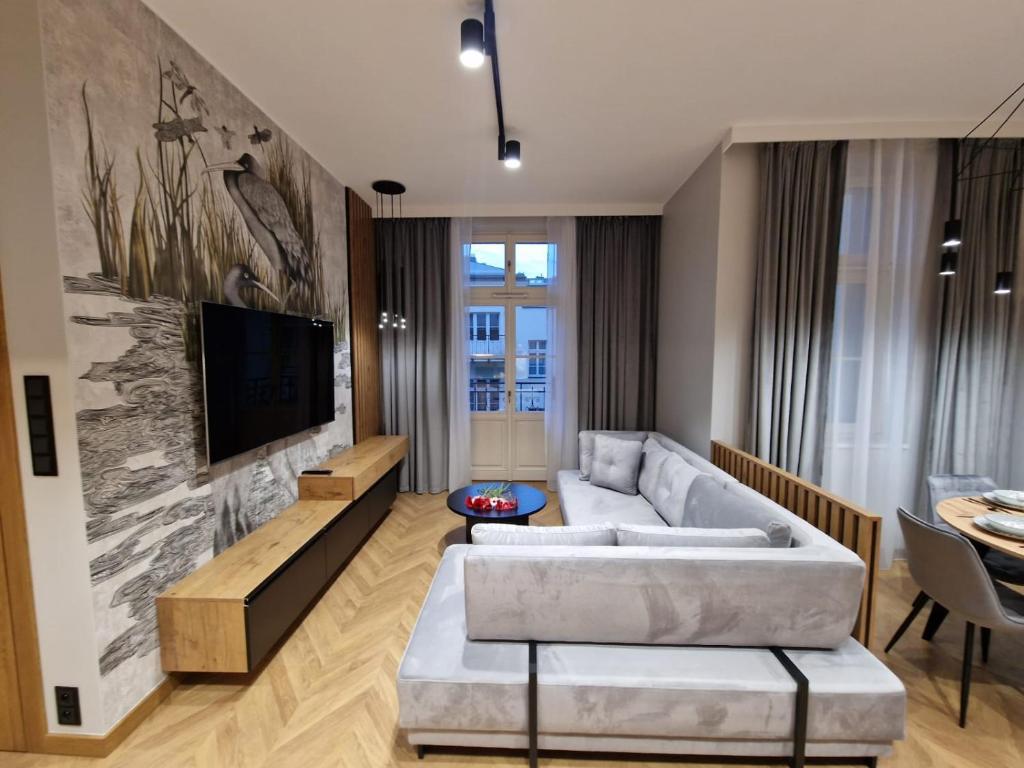 a living room with a couch and a tv at Apartamenty Sebastiana in Kraków