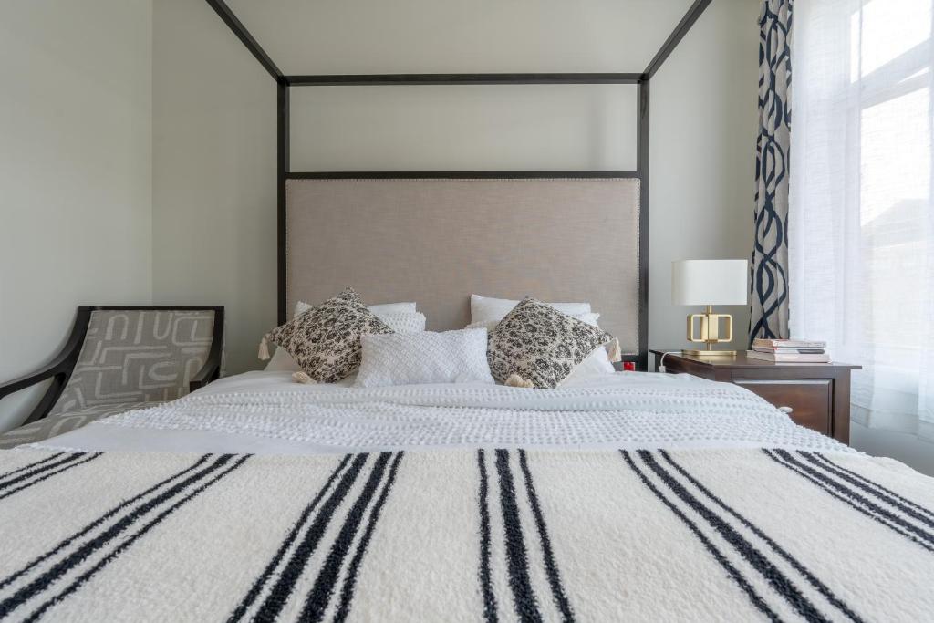a bedroom with a large bed with a large headboard at Room 1 of Lovely Montgomery Home, downtown Calgary in Calgary