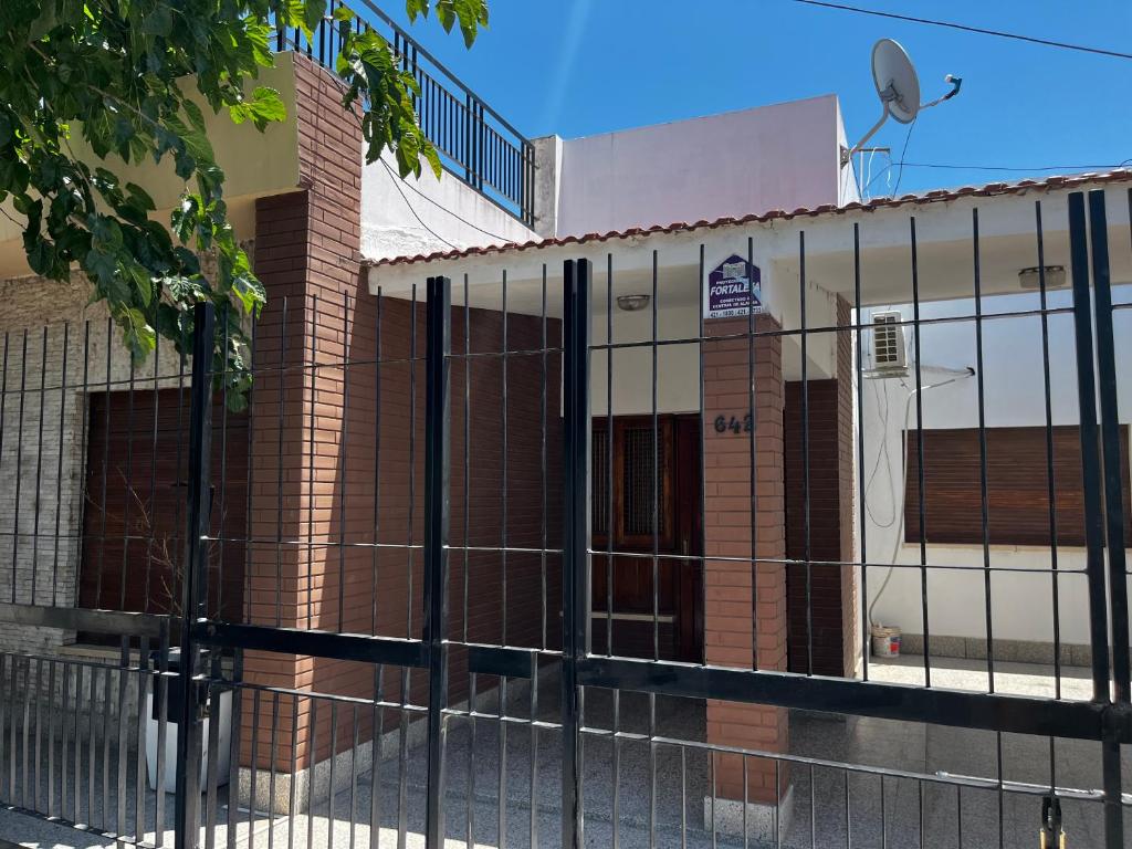 a building with a fence in front of it at Casa Rava in Santiago del Estero