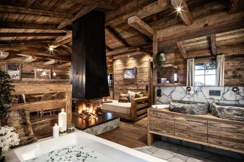 a large bathroom with wooden walls and a tub at Prechtlgut in Wagrain