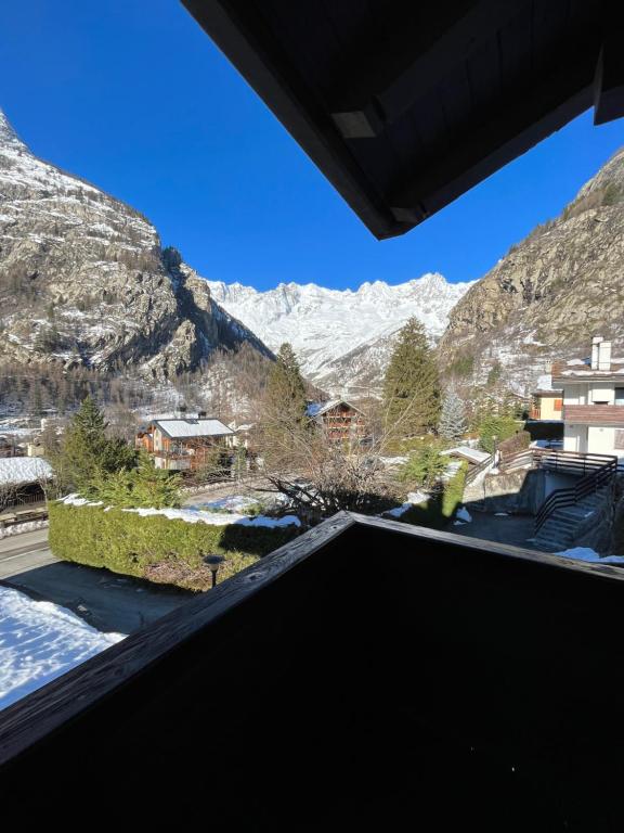 a view from the balcony of a house in the mountains at la saxe coumayeur in Courmayeur