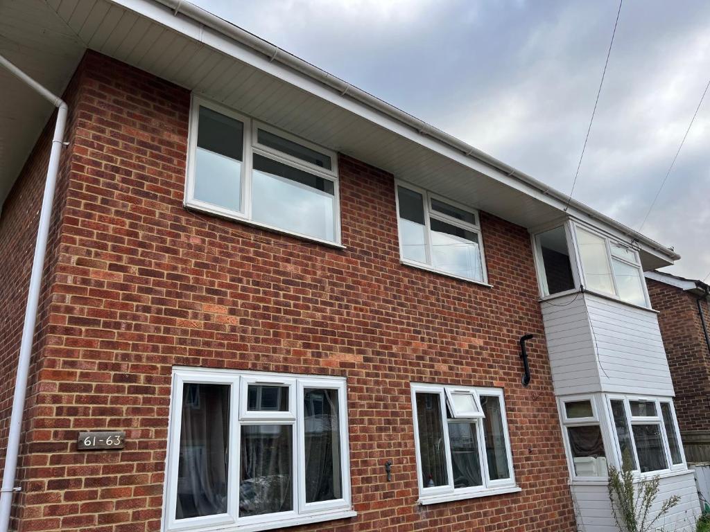 a brick house with white windows on it at St Denys 2 bedroom flat, Convenient location next to station, Great for contractors in Southampton