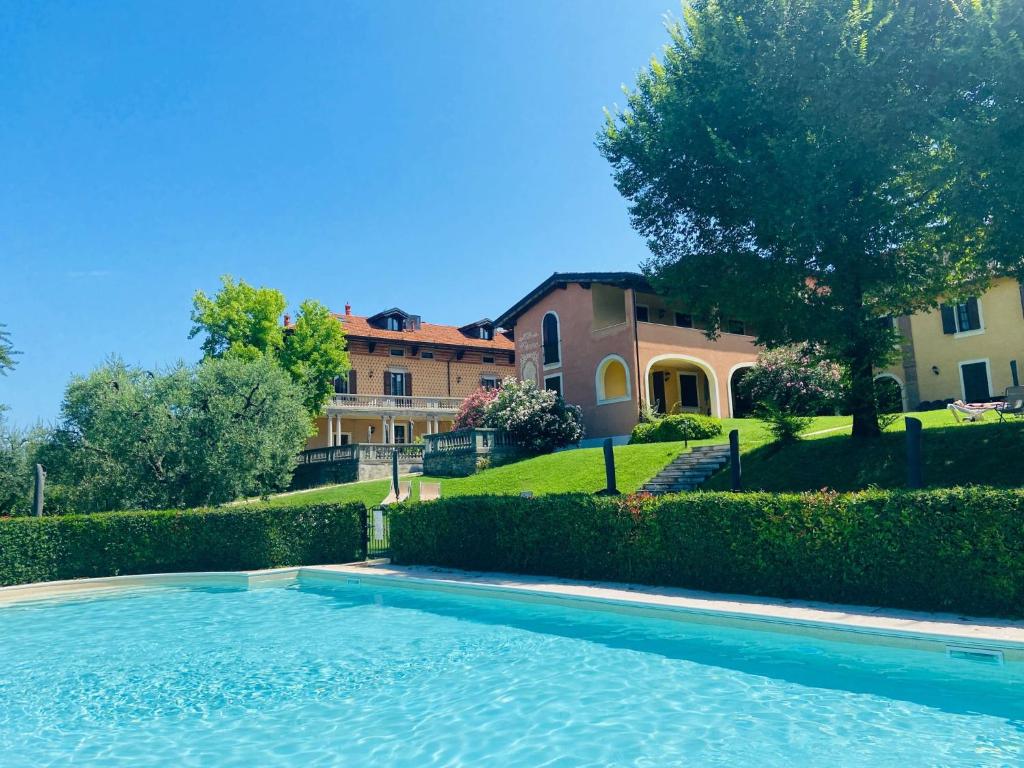 a swimming pool in front of a house at Villa Santa Caterina in Manerba del Garda