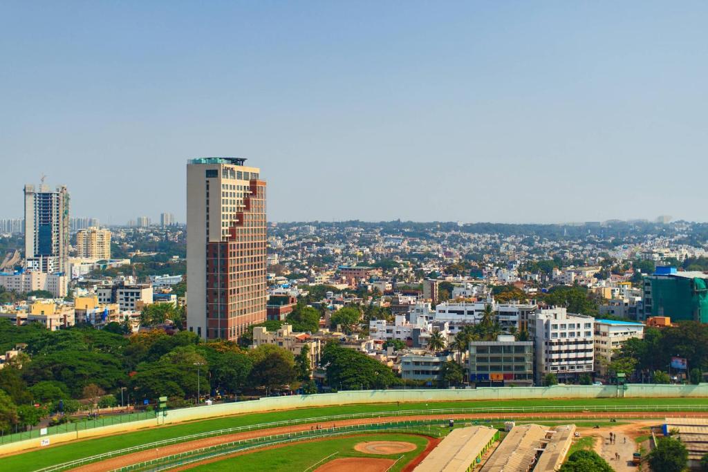 Blick auf eine Stadt mit einem hohen Gebäude in der Unterkunft Renaissance Bengaluru Race Course Hotel in Bangalore
