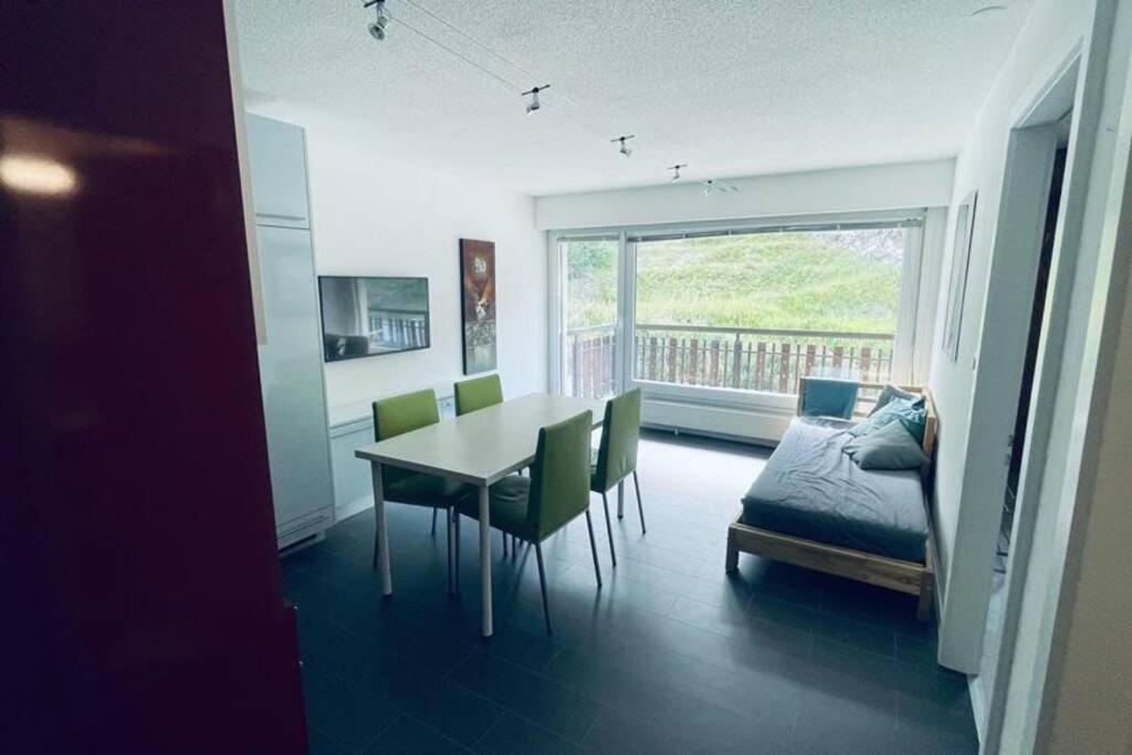 een eetkamer met een tafel en stoelen en een bed bij Escapade montagnarde idéale ! in Vex