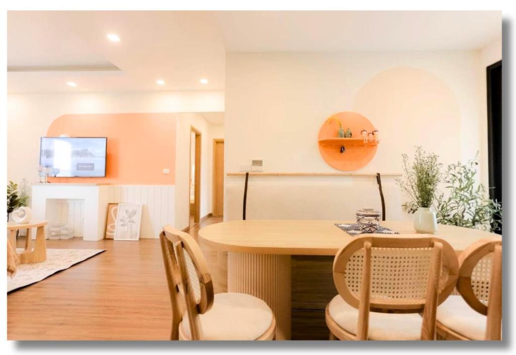 a dining room and living room with a table and chairs at FLC Luxury Apartment Quy Nhon in Quy Nhon