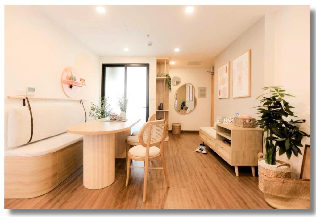 a room with a table and a bed in a room at FLC Luxury Apartment Quy Nhon in Quy Nhon