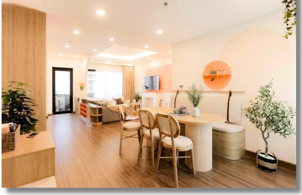 a kitchen and living room with a table and chairs at FLC Luxury Apartment Quy Nhon in Quy Nhon