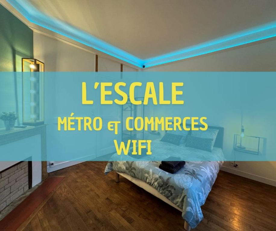 a room with a bed with a blue light at L'Escale in Rennes
