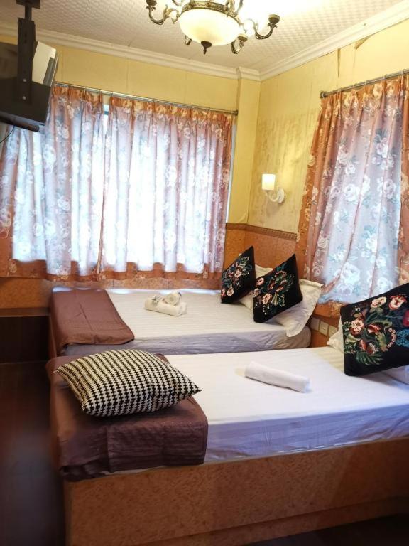 Postel nebo postele na pokoji v ubytování Prime Star Inn