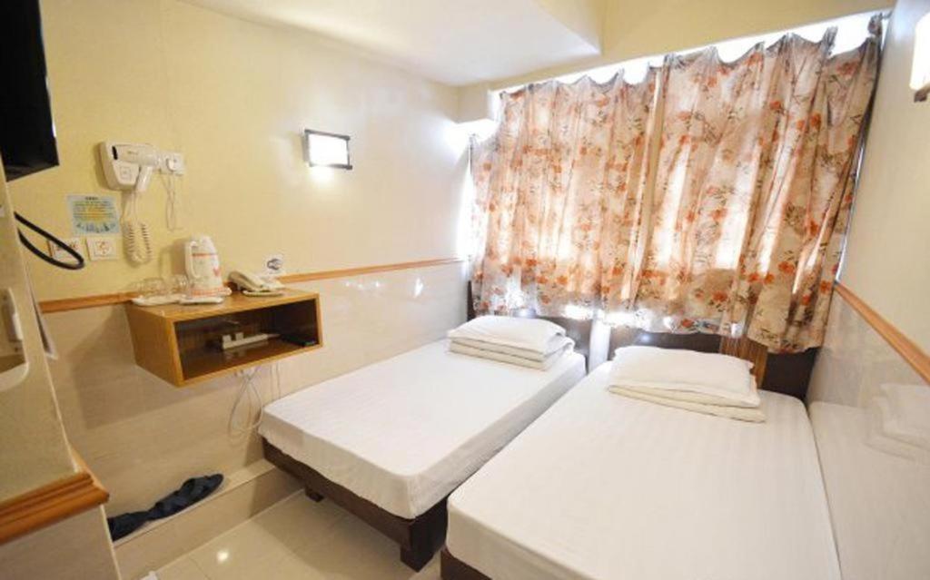 Postel nebo postele na pokoji v ubytování Prime Star Inn