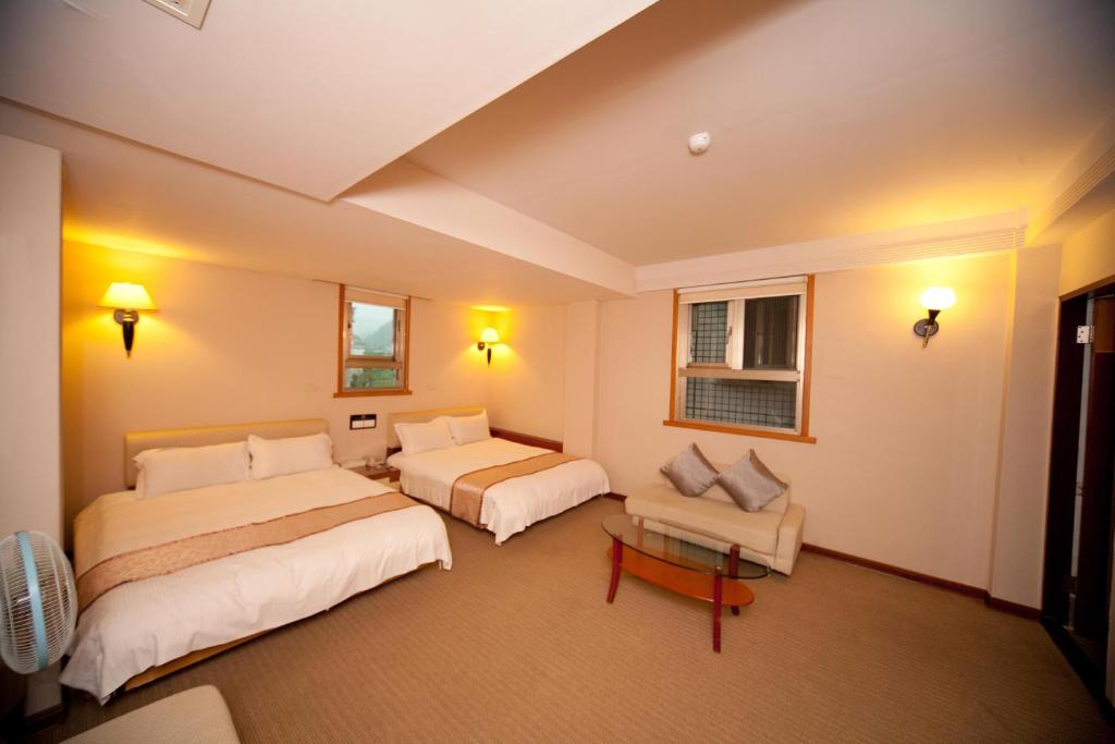 Postel nebo postele na pokoji v ubytování Tian Long Hotel