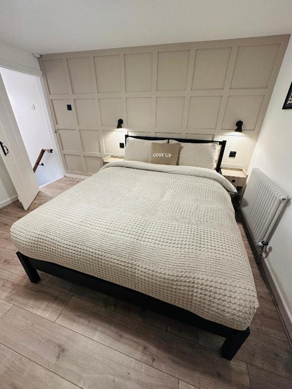 a bedroom with a large bed in a room at The Nook Cottage, Parkgate, Wirral in Parkgate