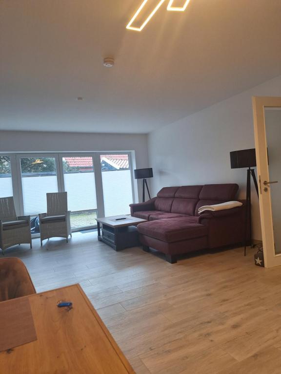 a living room with a couch and a table at Apartment Annies Deichliebe in Krummhörn