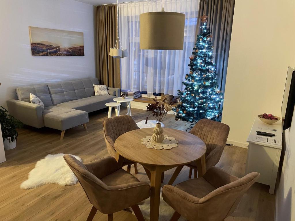 a living room with a christmas tree and a table at the house in Poprad