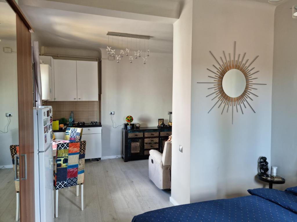 a kitchen and a living room with a mirror on the wall at Cosy studio in Bucharest