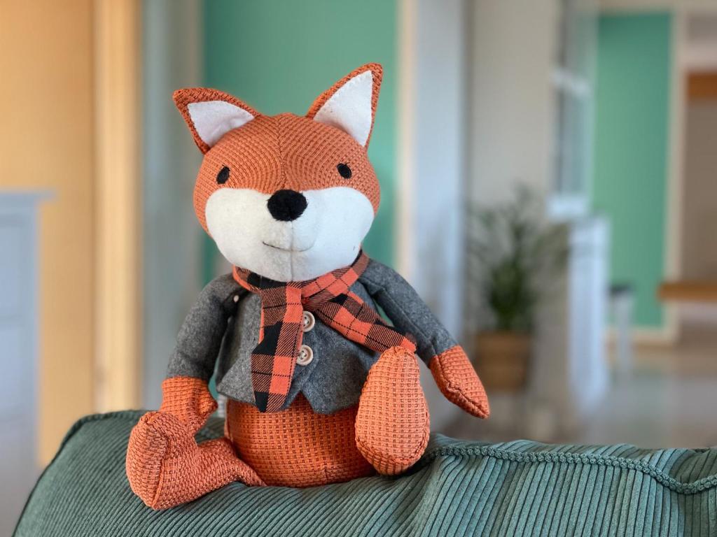 a stuffed fox toy sitting on top of a couch at Ferienwohnung Hintermoos in Kißlegg