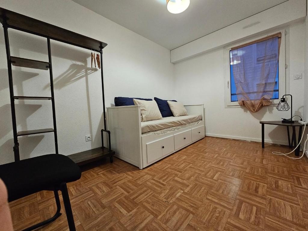 ein Wohnzimmer mit einem Sofa und einem Fenster in der Unterkunft Chambre centre ville de Cluses in Cluses