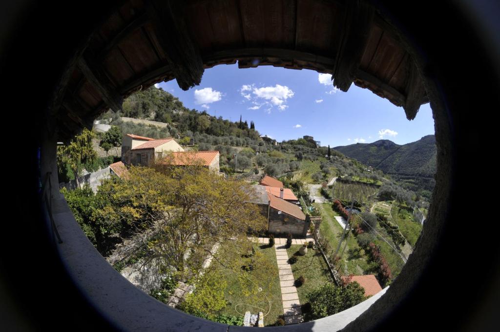 a view from a round window of a village at Agriturismo La Contessa in Finale Ligure