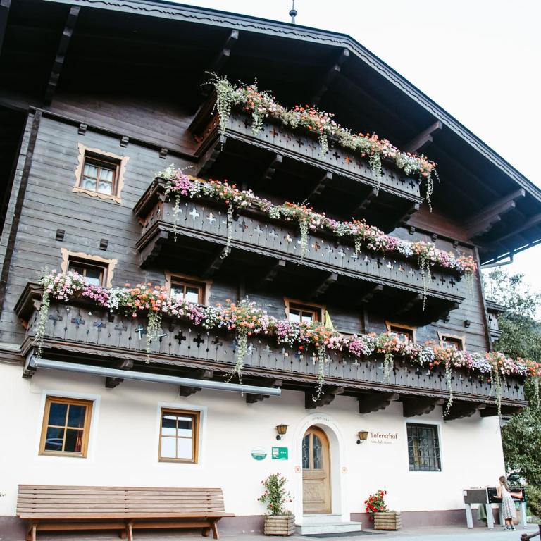 an old house with flowers on the balconies at Tofererhof in Bad Hofgastein