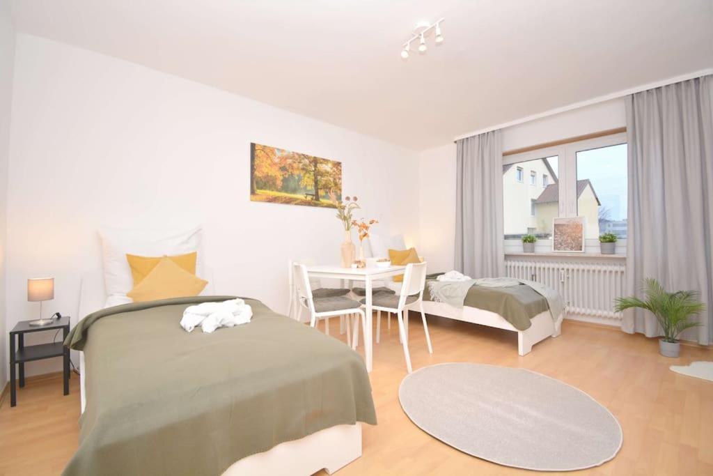 a bedroom with a bed and a desk and a table at KU01-RI Apartment in Kulmbach EG in Kulmbach