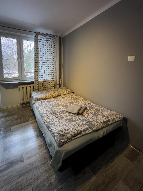 Posteľ alebo postele v izbe v ubytovaní Kwadrat B&B Jałowego