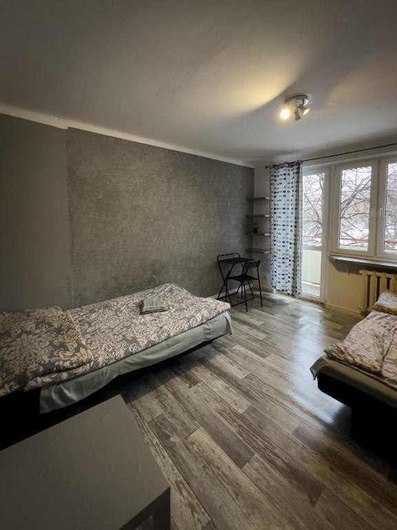 Posteľ alebo postele v izbe v ubytovaní Kwadrat B&B Jałowego