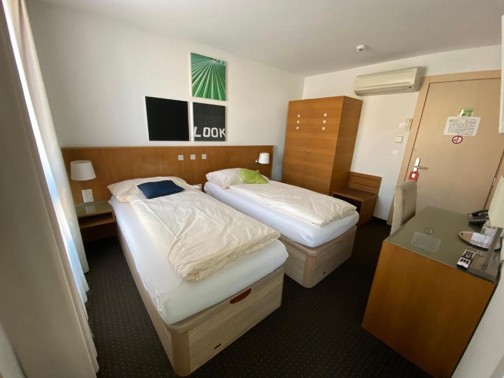 Postel nebo postele na pokoji v ubytování Businesshotel Lux