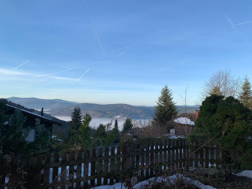 a wooden fence with mountains in the background at Schönblick23 in Langfurth 