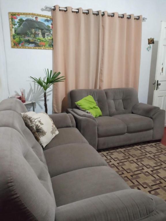 a living room with a gray couch at Lazer Caraguatatauba ✓ in Caraguatatuba