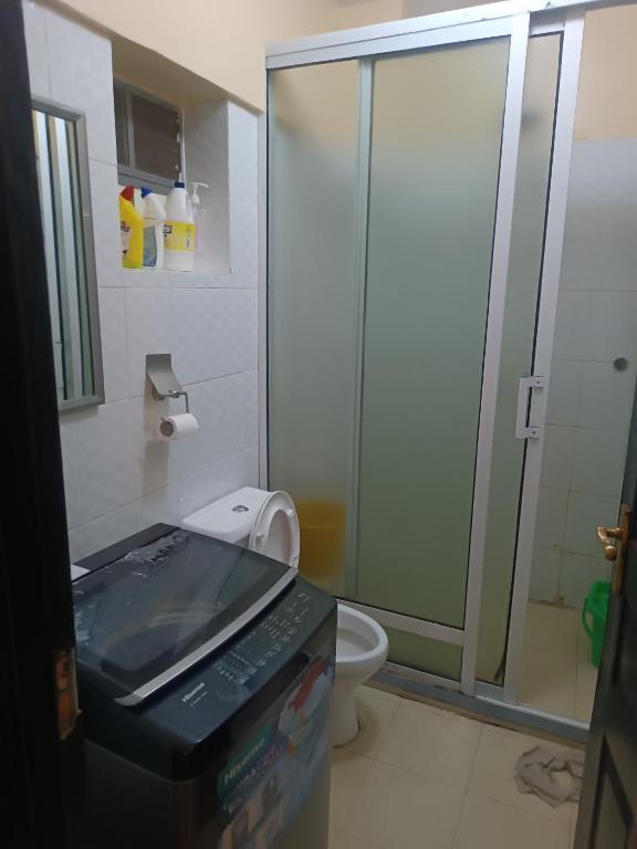 a bathroom with a glass shower and a toilet at Angel Asenath 2Bedroom apartment in Nairobi