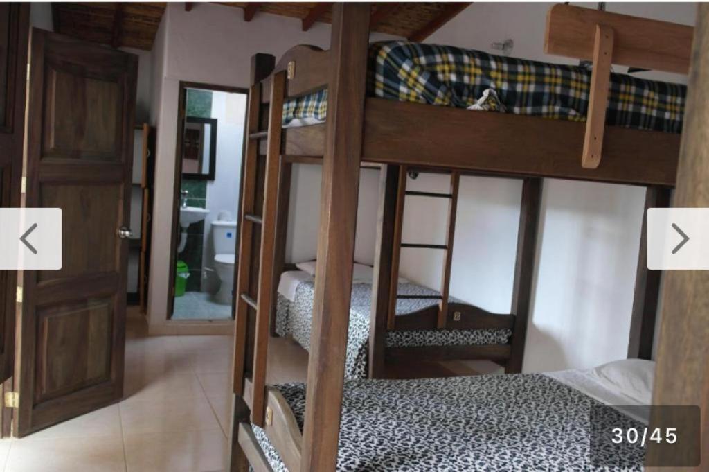 two bunk beds in a room with two doors at S. Peppers Hostel in Jardin