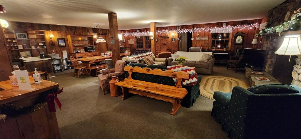 a living room with a couch and a table at Turn of River Lodge in Killington