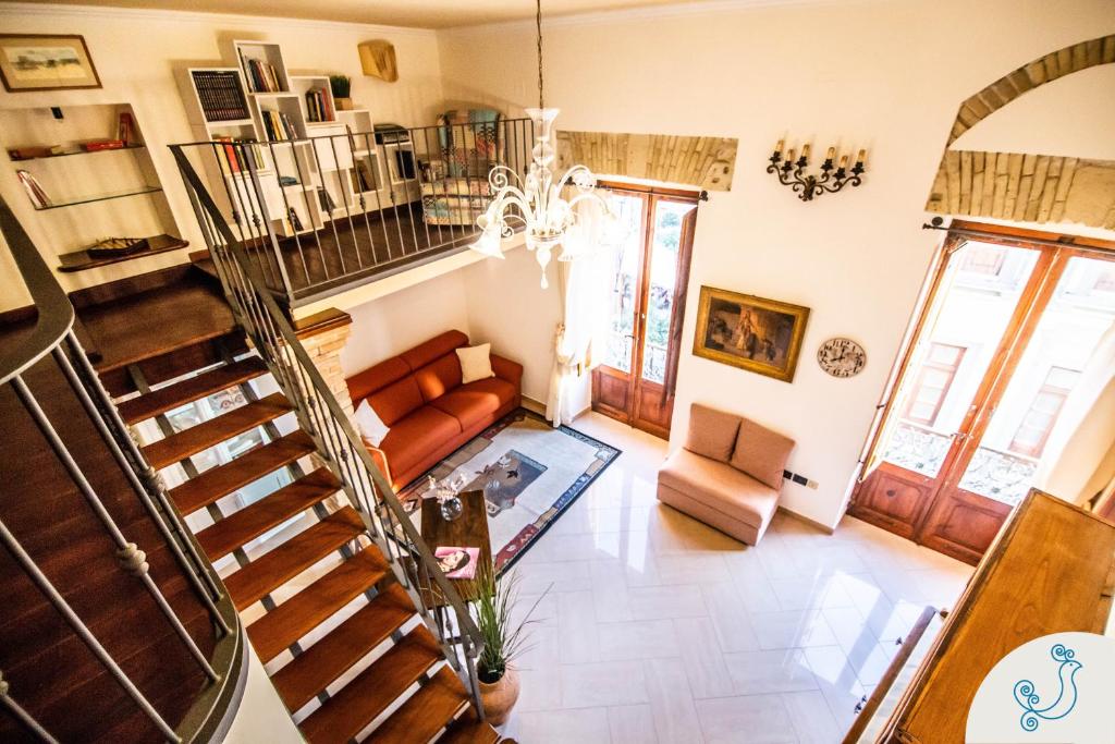 a living room with a staircase and a couch at Manno 81 - Charming historic apartment in Cagliari