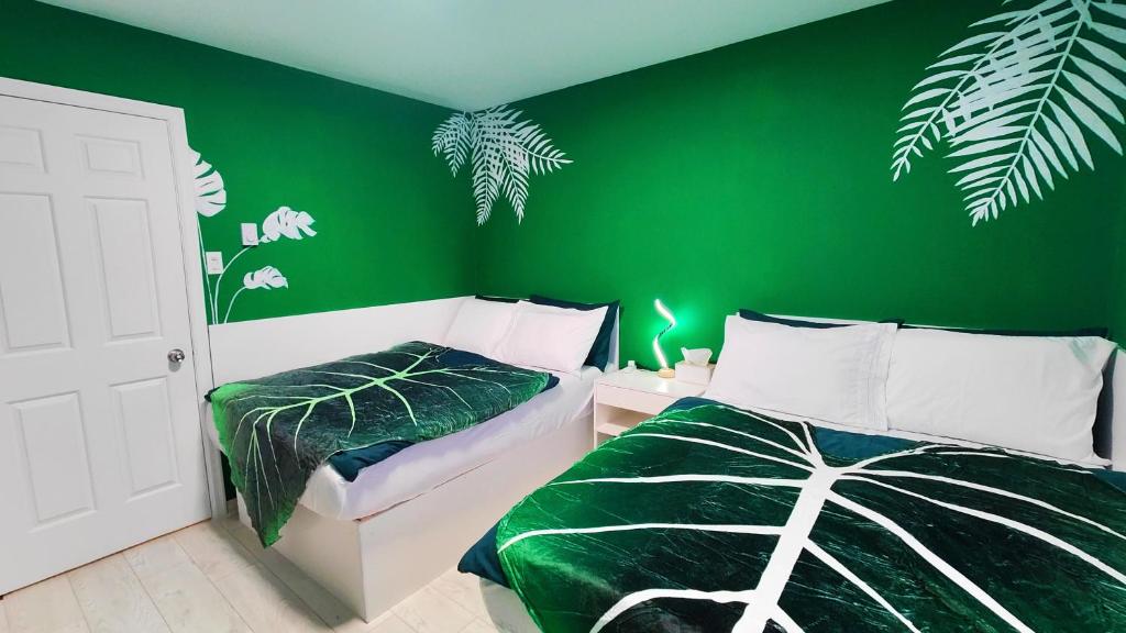 a green bedroom with a bed and a green wall at Fresh & Bright Private Suite in Lower Sackville