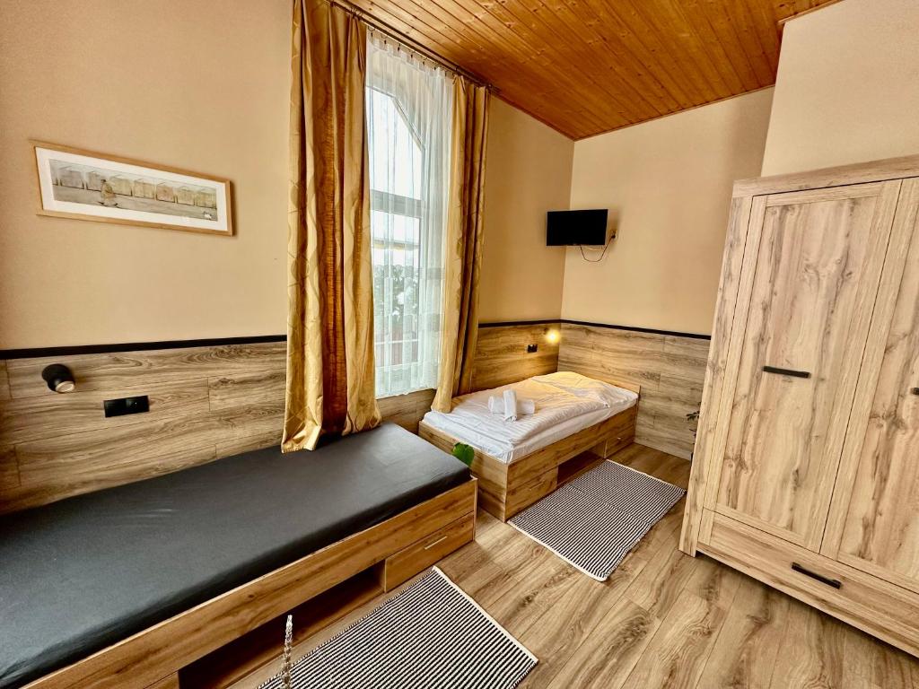 Postel nebo postele na pokoji v ubytování Penzion Manderlak