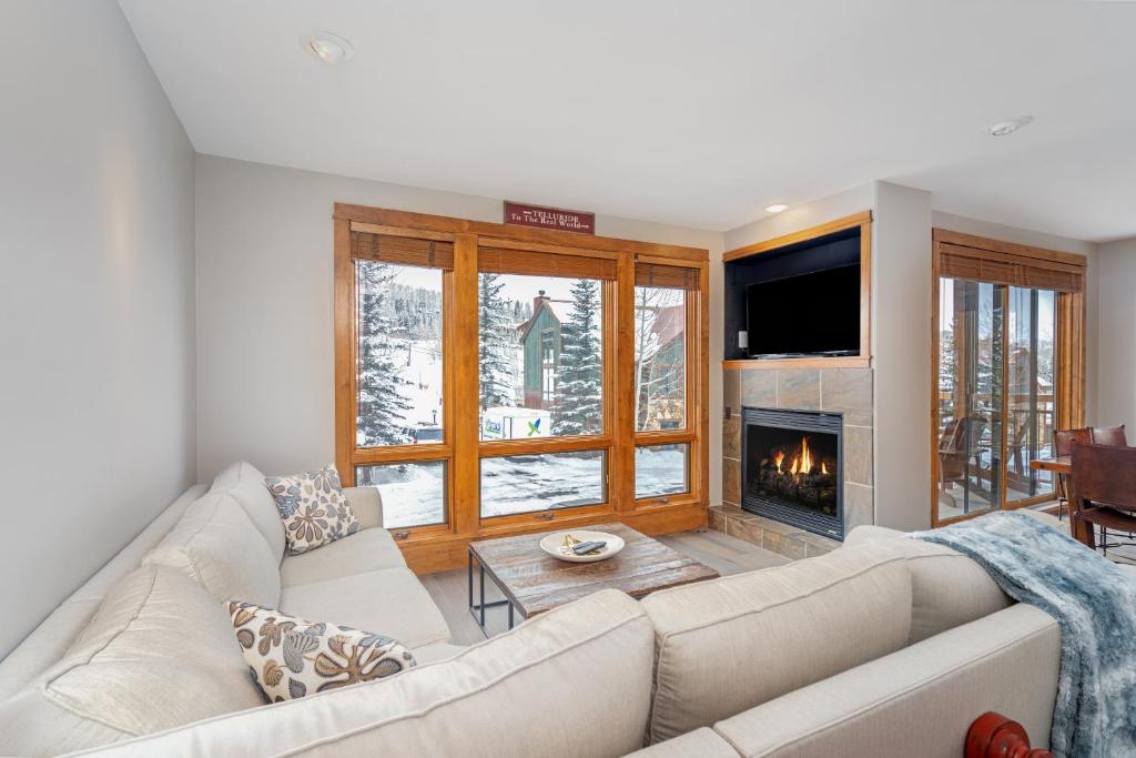 a living room with a couch and a fireplace at Ski in ski out Terraces Condo in Telluride