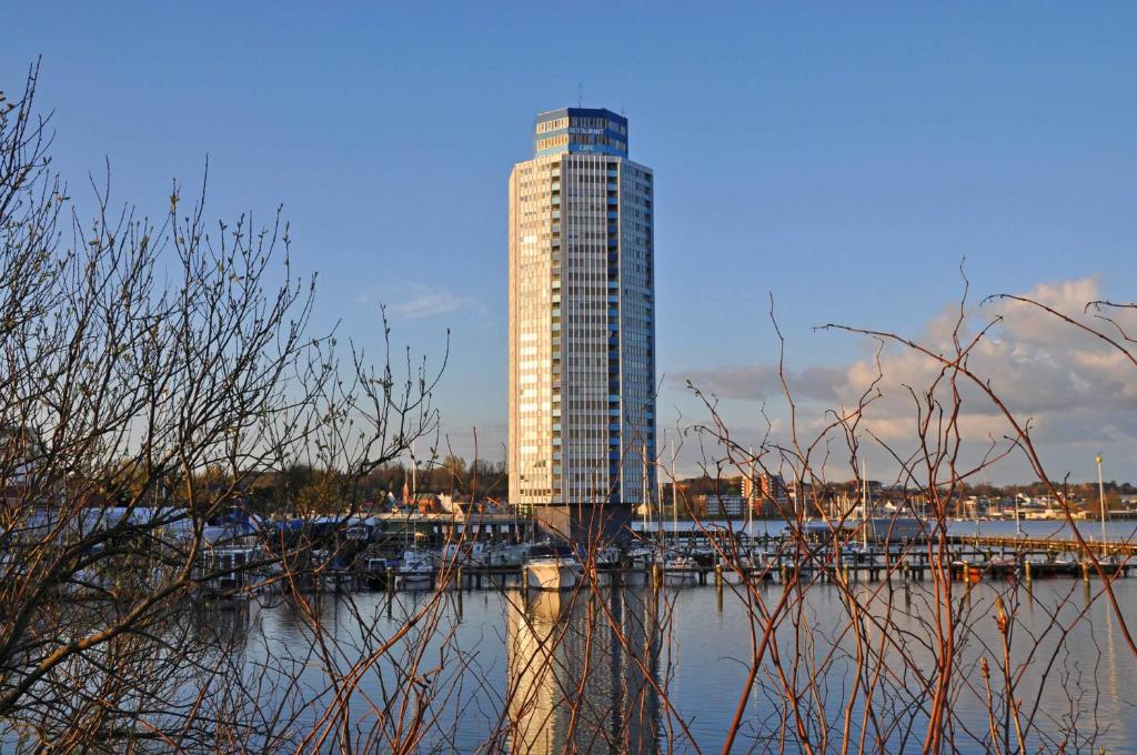 a tall building next to a body of water at Ferienappartments Schleswig in Schleswig