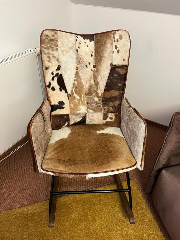 an old chair with a blanket on top of it at Apartmán Bílé Labe in Špindlerův Mlýn