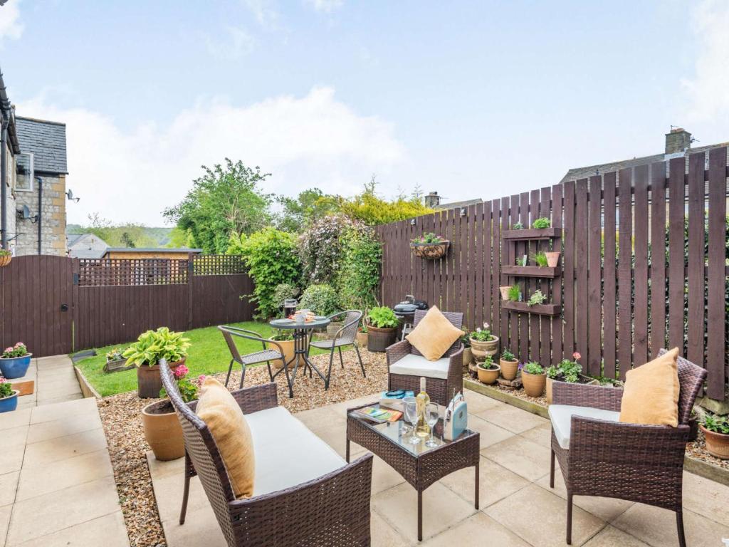 a patio with chairs and tables and a fence at 1 Bed in Bakewell 88085 in Bakewell